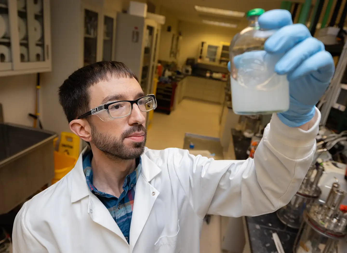 A research technician holds a liquid sample.