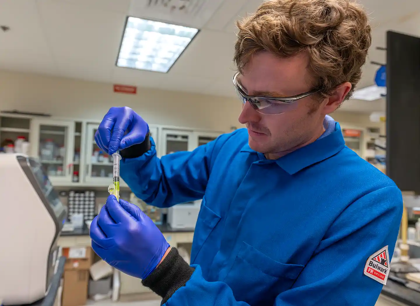 A bioengineering researcher prepares a protein sample for purification.