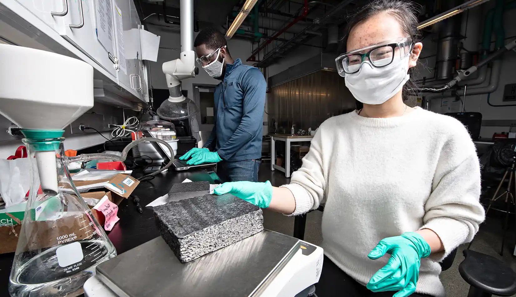 Two postdoc researchers in a lab at NREL.