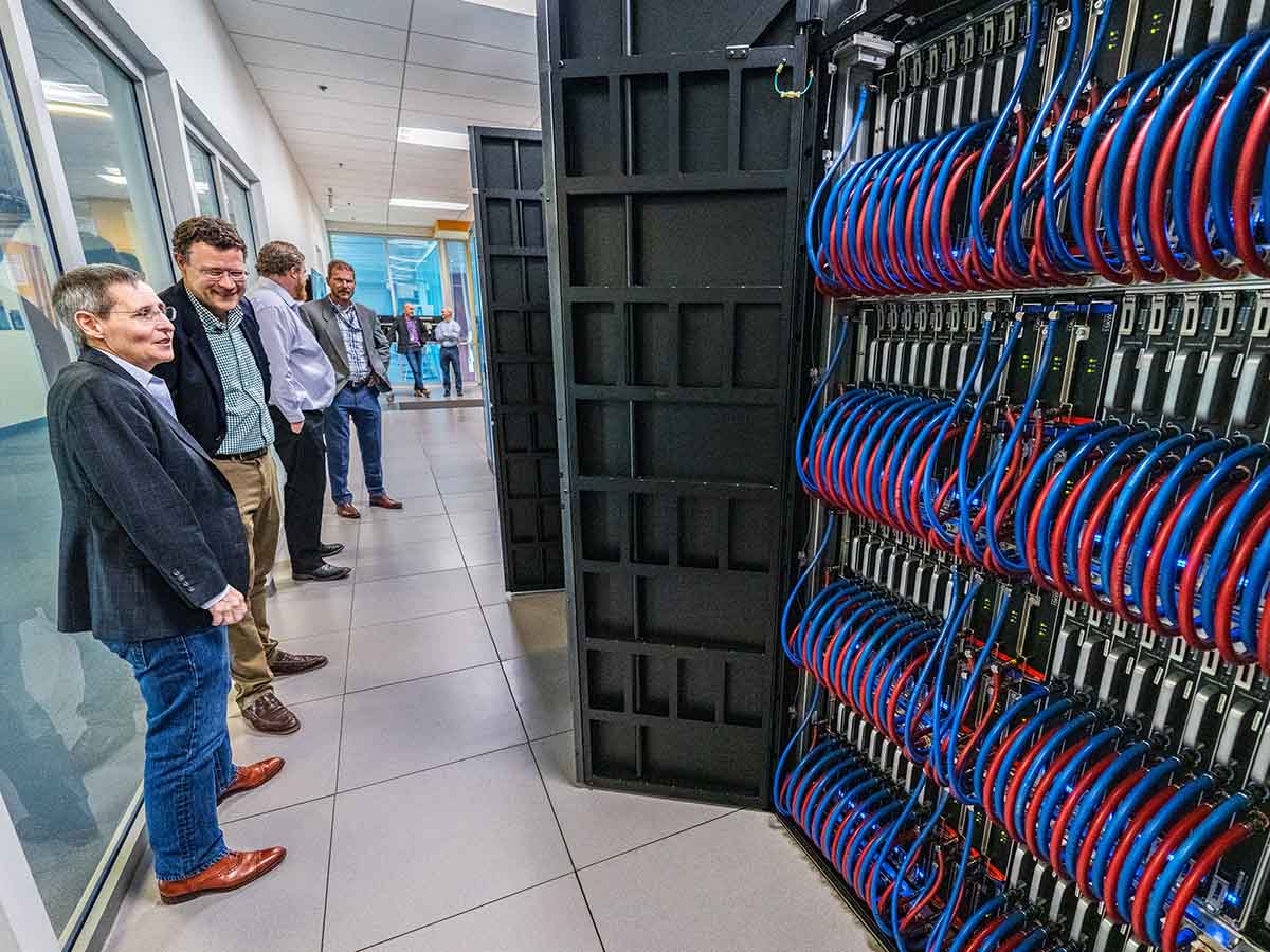 Researcher analyzing 2D data visualizations on a wall-sized screen.