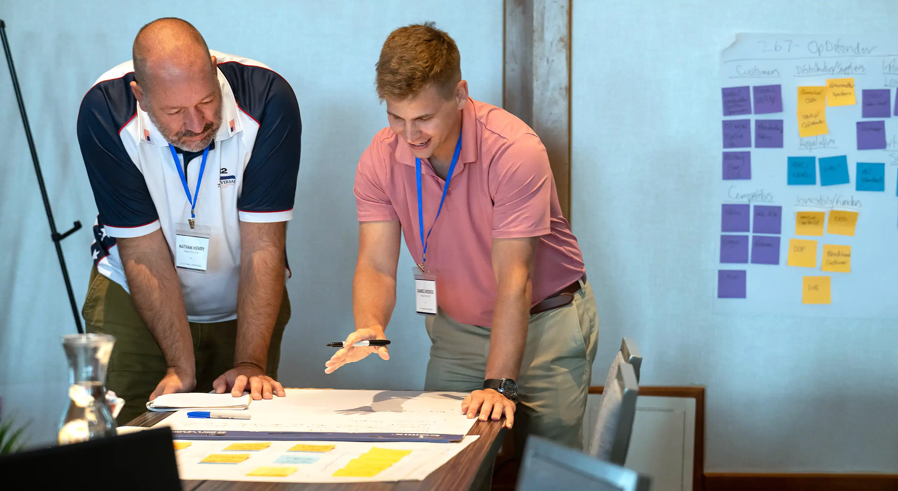 Two people discuss a plan during a working session.