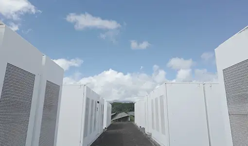 Continue reading about Rows of batteries under a blue sky with some clouds.