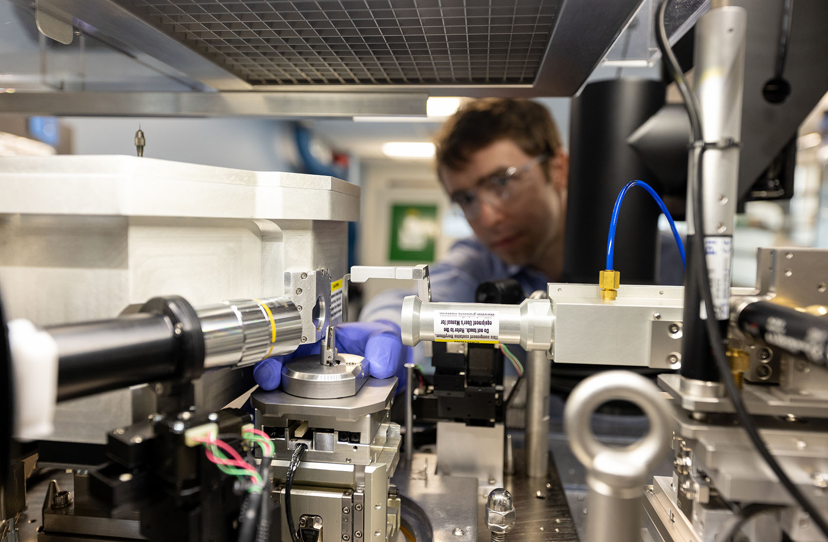 A person operating an X-ray nano-computed tomography system machine.
