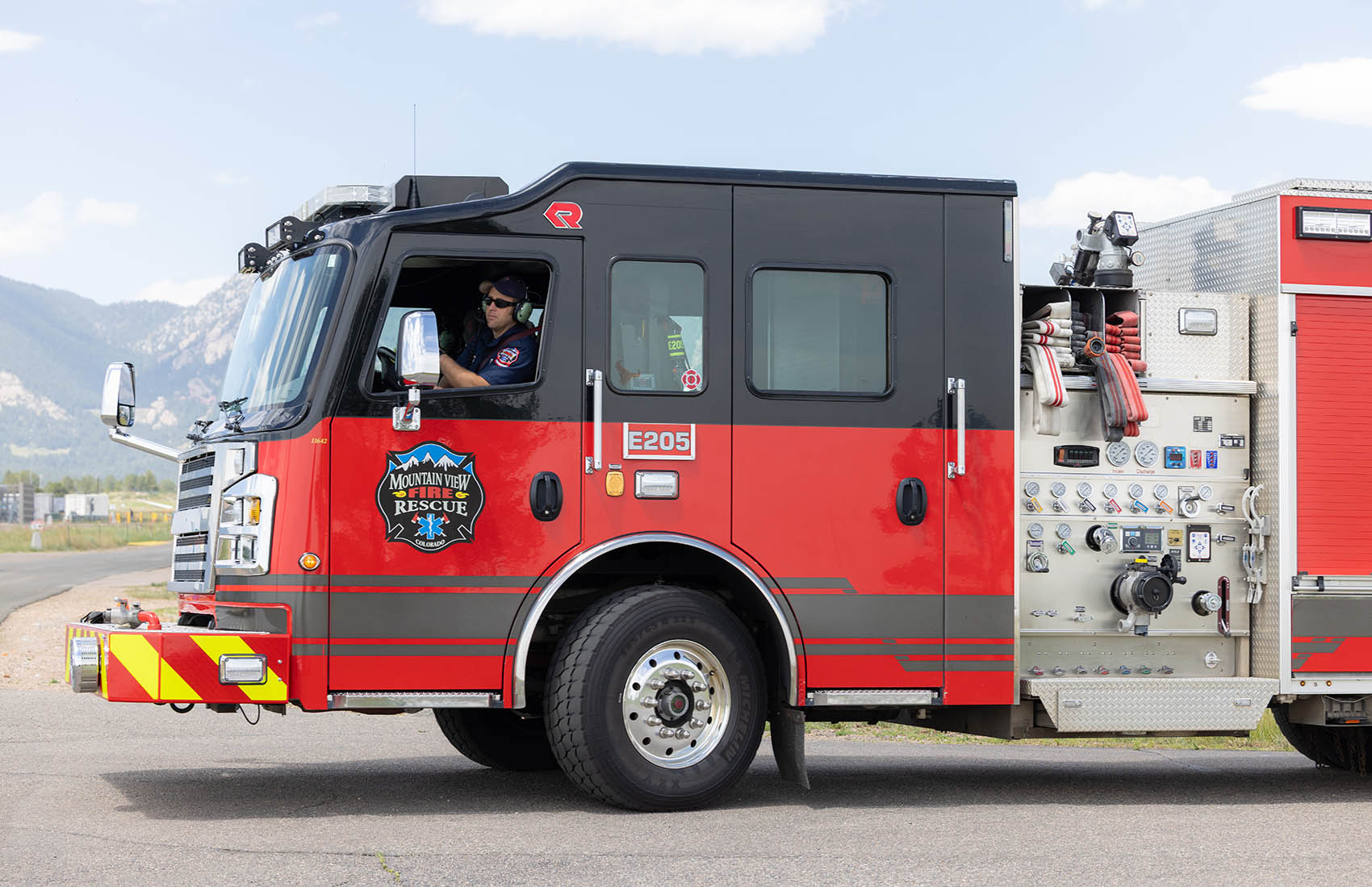 A person driving a fire truck.