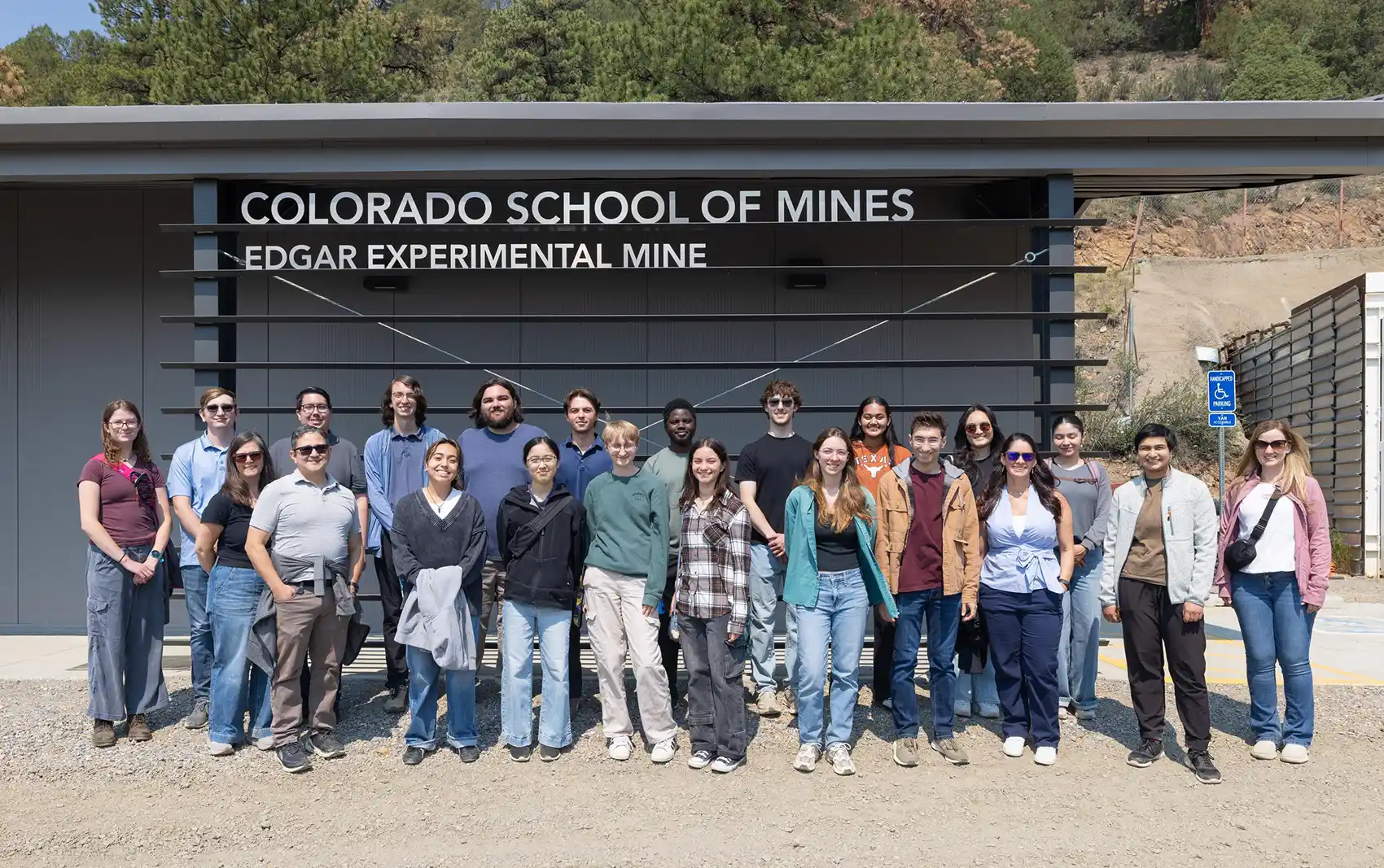 Twenty-two people standing outside a building with the text Colorado School of Mines Edgar Experimental Mine