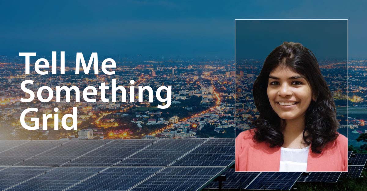 Solar panels in the forefront of city lights overlain by 