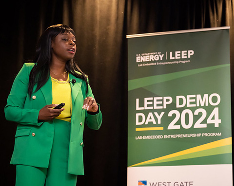 A woman speaking on a stage.