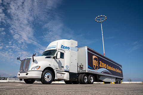 A hydrogen fuel cell truck with an advertisement reading 