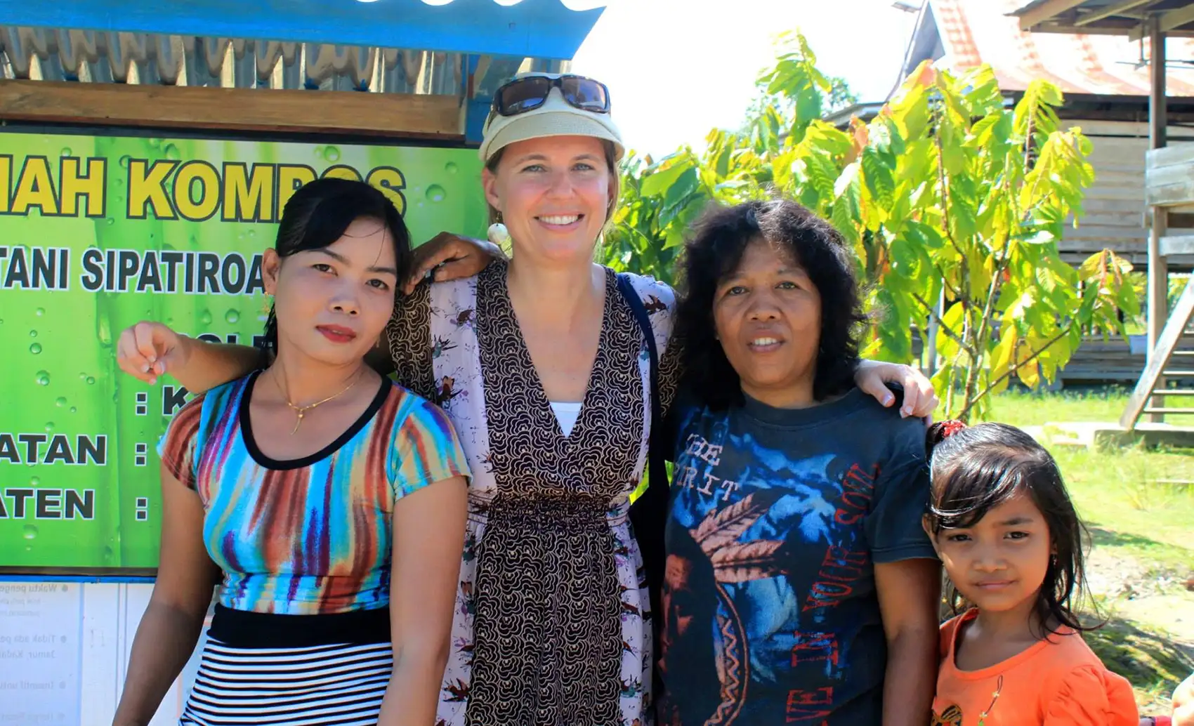 20250916-love-of-biology-fuels-kristi-moriarty-career-nrel-indonesia Three adults and a child stand in front of a sign.