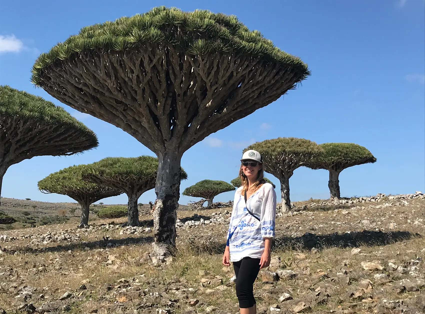 20250916-love-of-biology-fuels-kristi-moriarty-career-nrel-yemen Kristi Moriarty stands in front of funnel-shaped trees.