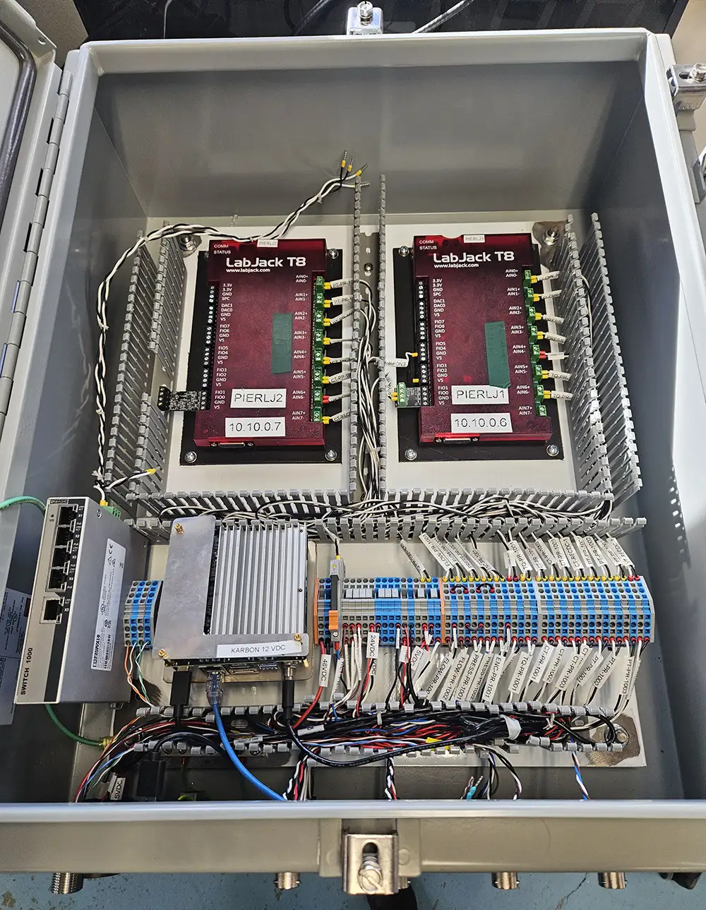 A metal box containing wires and hardware.