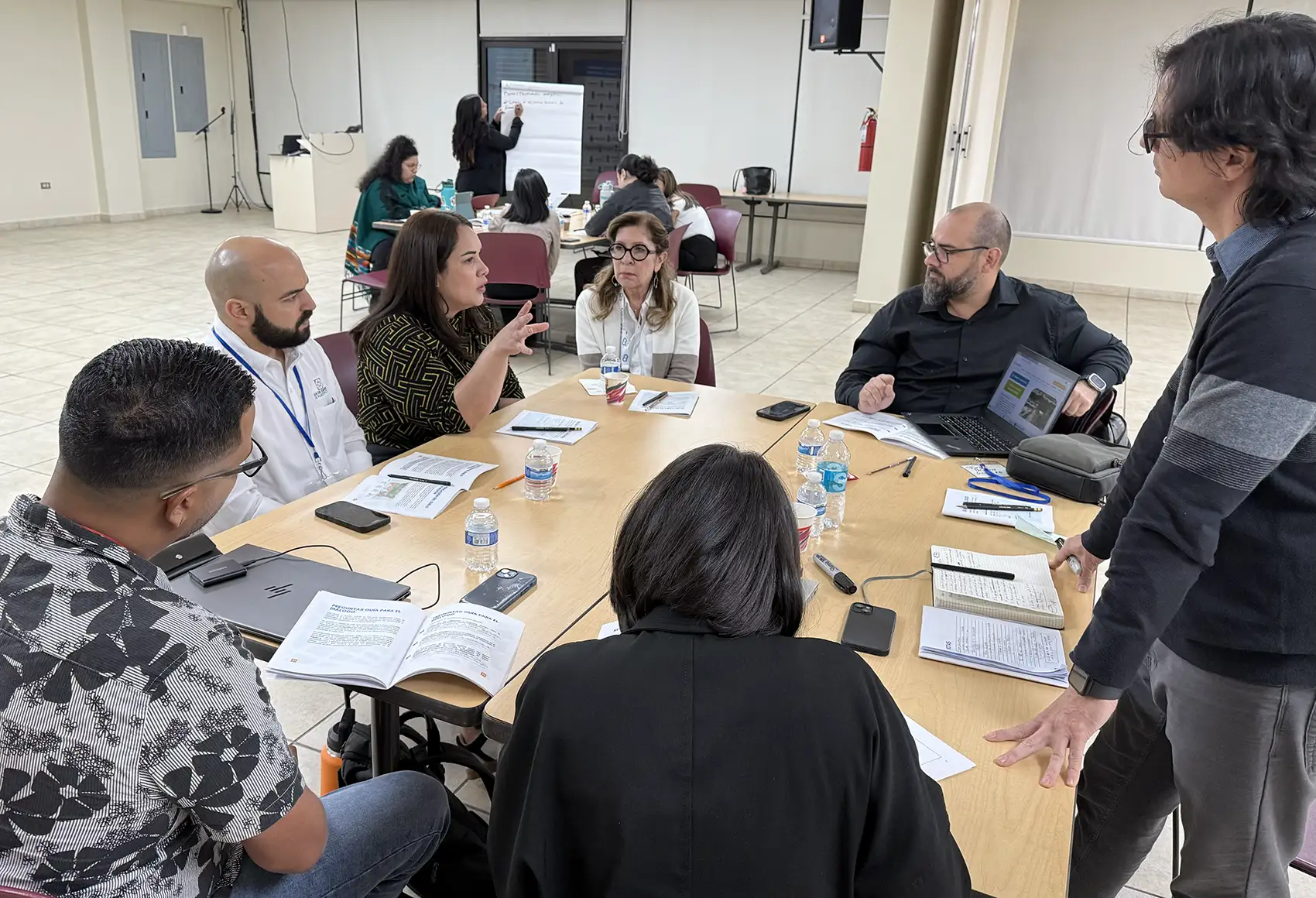 A group of people gathered around a table to converse.