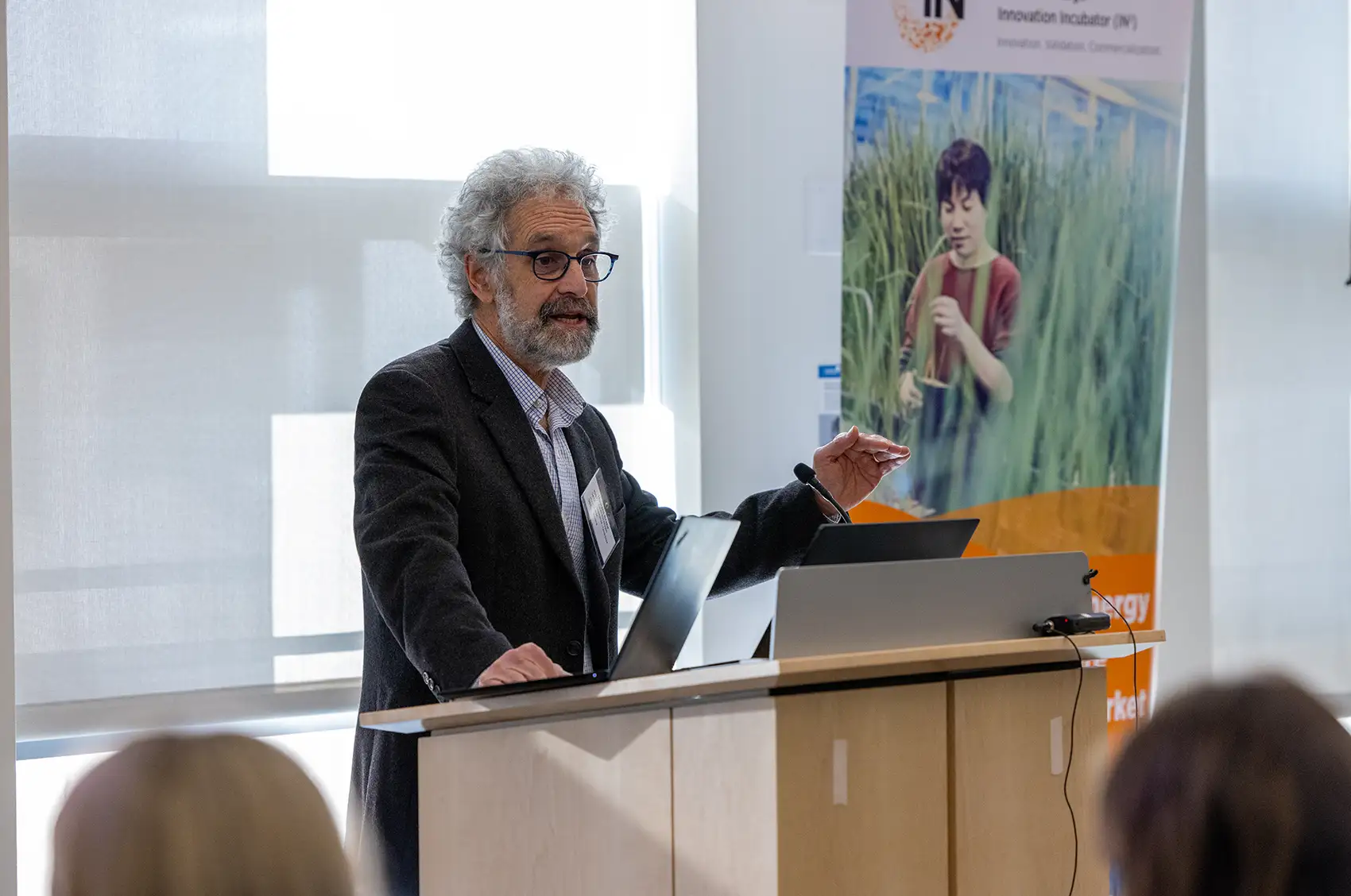 Howard talking while standing behind a podium.