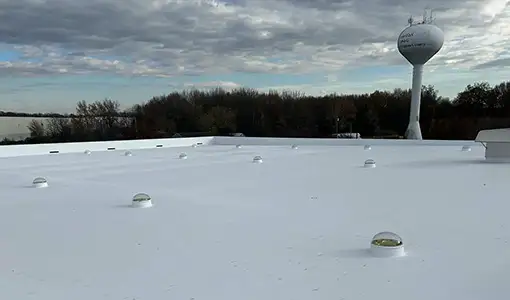 Continue reading about A wide view of a rooftop with a white coating.