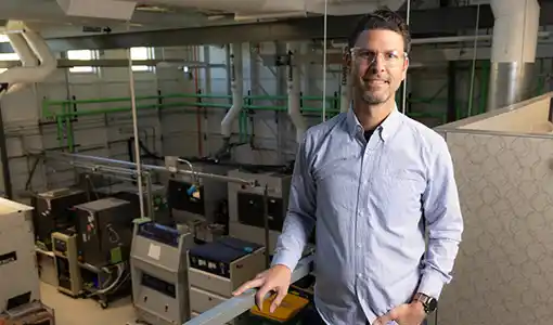 Continue reading about A man standing in the Vehicle Testing and Integration Facility (VTIF).