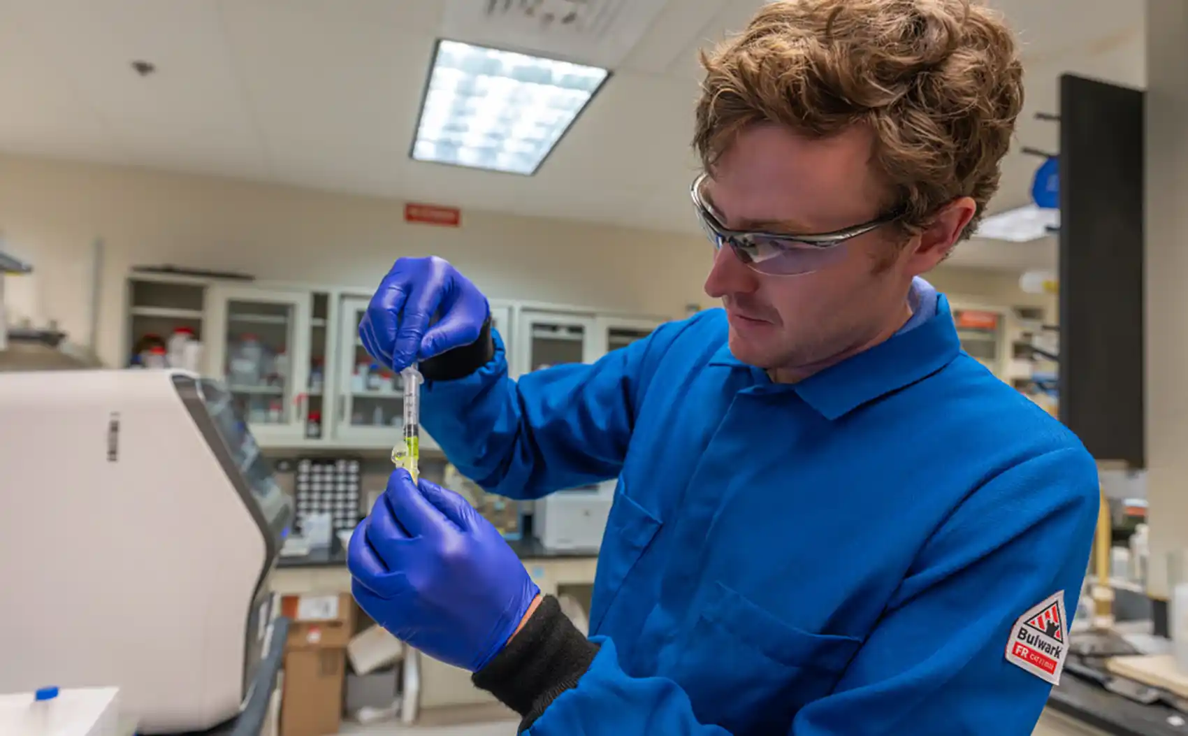 A National Laboratory of the Rockies bioengineering postdoctoral researcher, Shawn Laursen, prepares a protein sample for purification.
