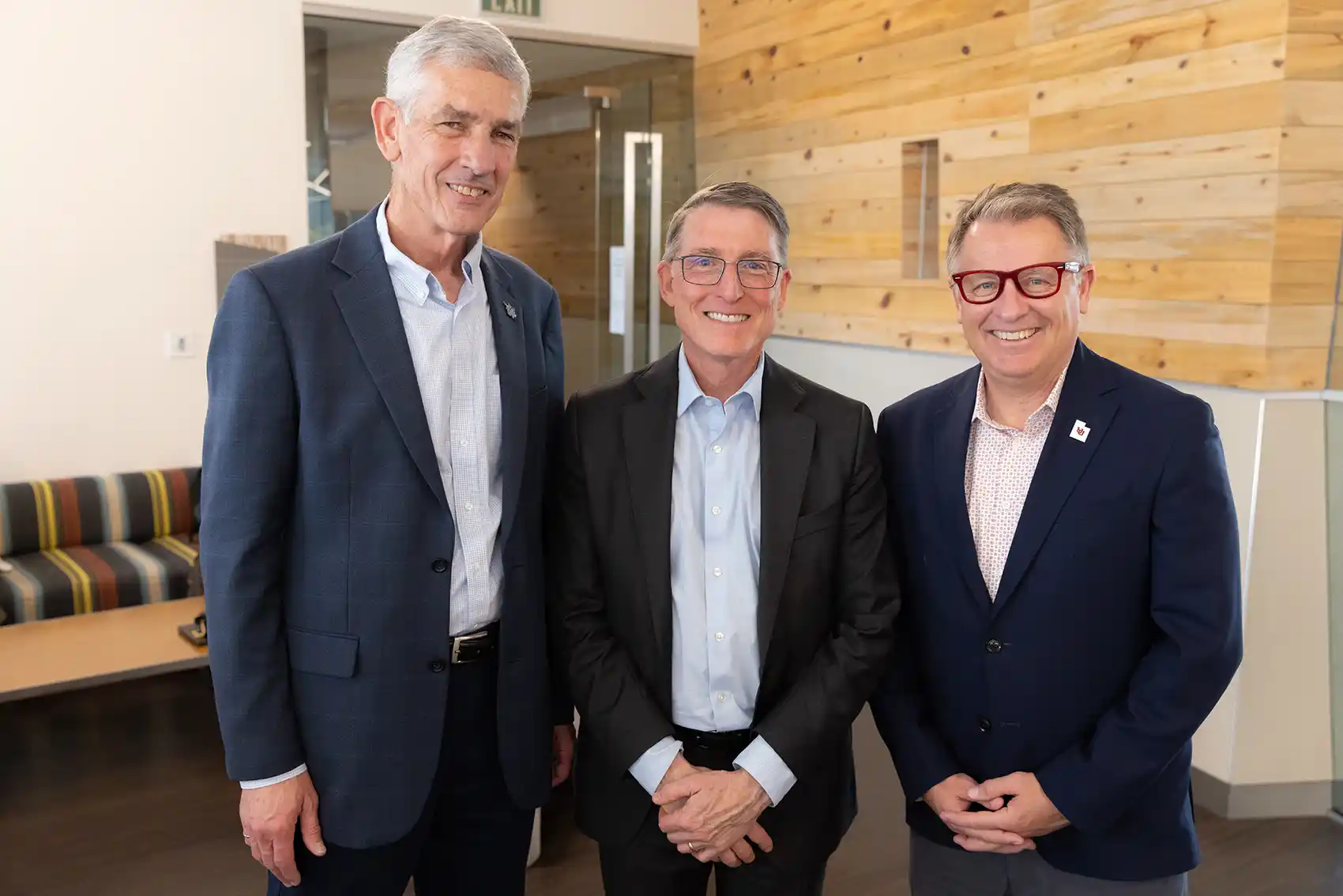 Three people smiling.