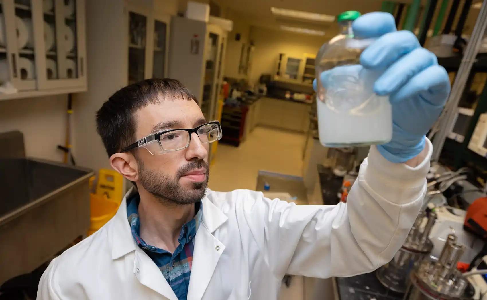 A research technician holds a liquid sample.