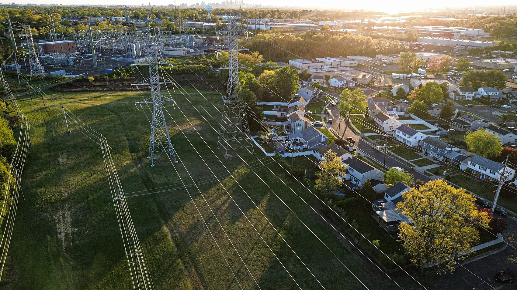 20260528-smart-energy-management-research-could-unlock-grid-flexibility-and-cost-savings-getty Power lines next to a residential neighborhood.
