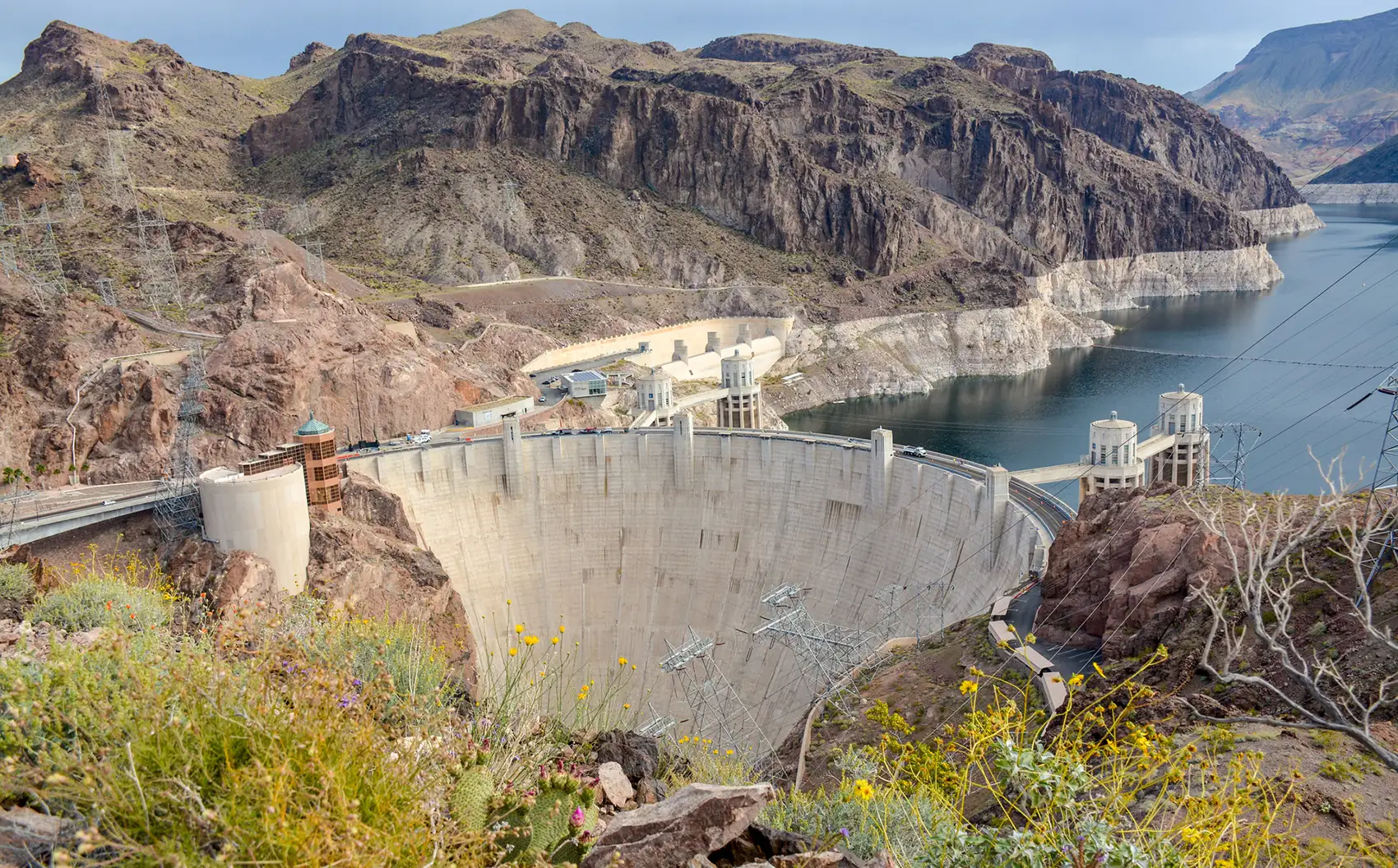 20260715-us-hydropower-faces-supply-chain-challenges-with-large-power-transformers-hoover-dam A photo with mountains, water, a dam, and plants.