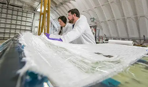 Two people in a large warehouse laboratory
