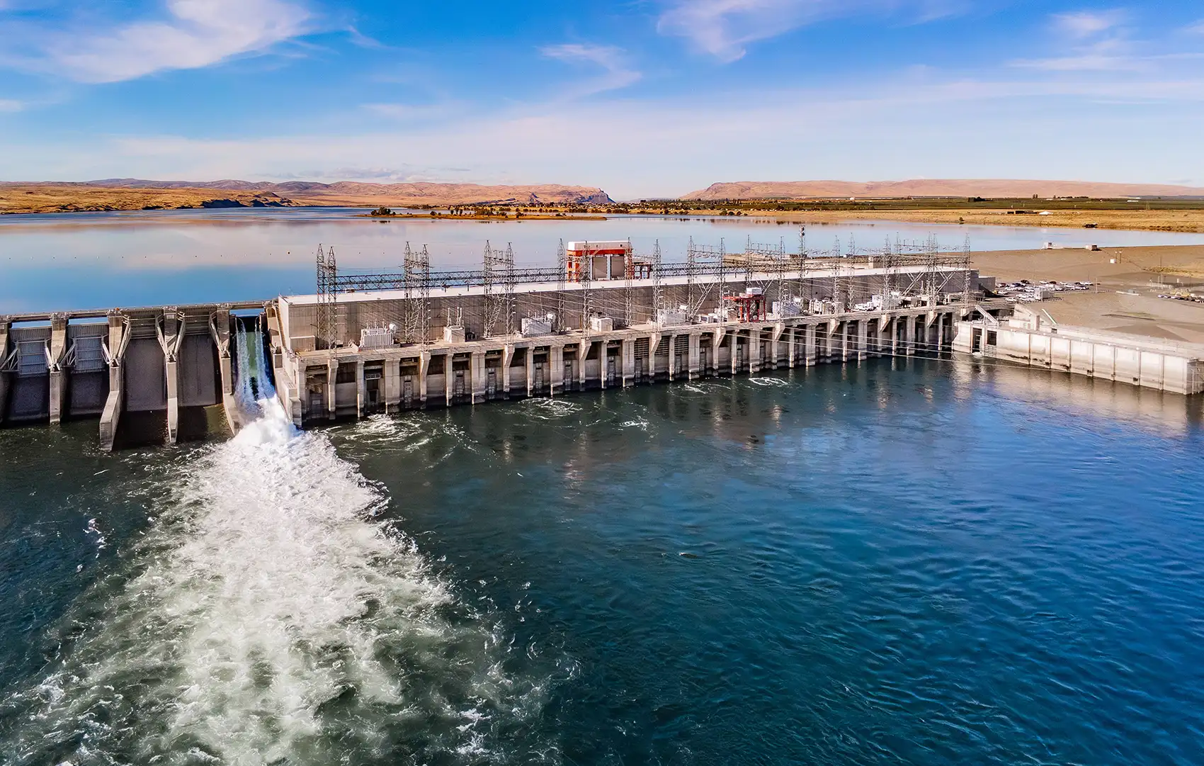 Photo of a hydropower generating station spanning a wide river.