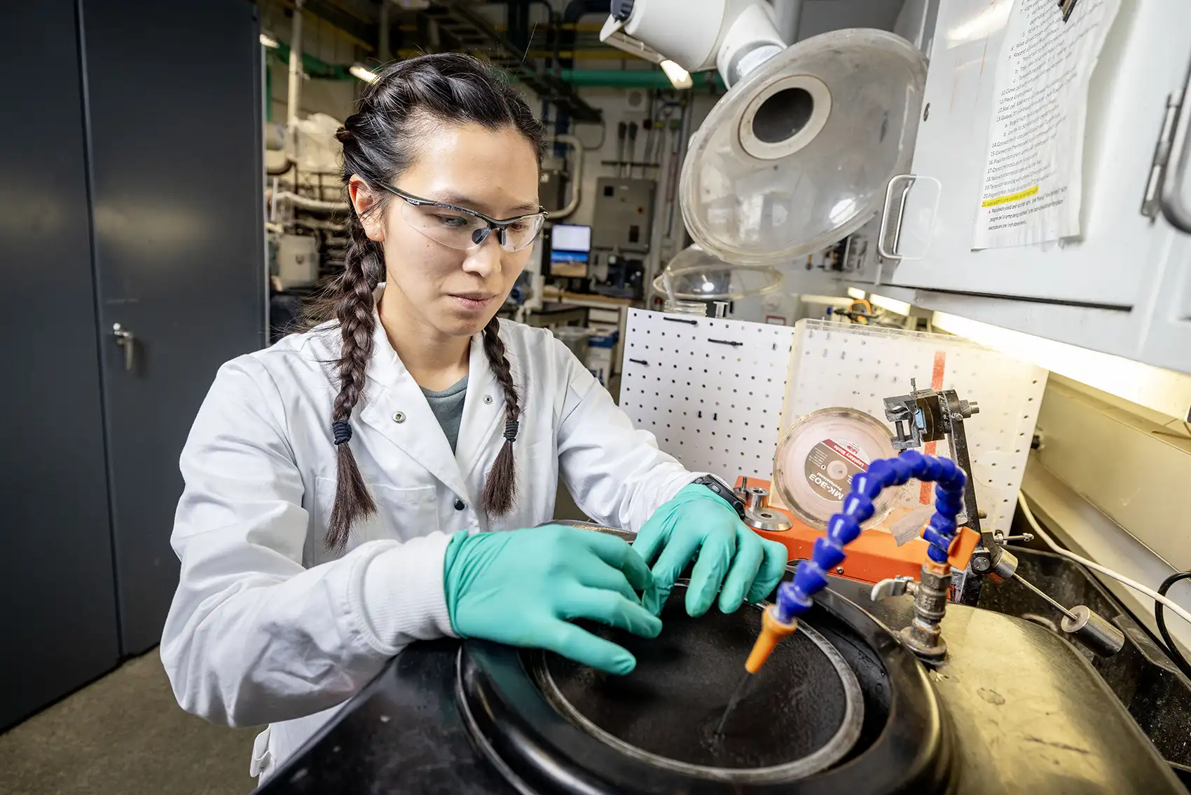 20261027-partners-for-critical-defense-nlr-and-natural-resources-research-institute-enhance-collaboration A researcher wearing gloves working in a sink with running faucet.