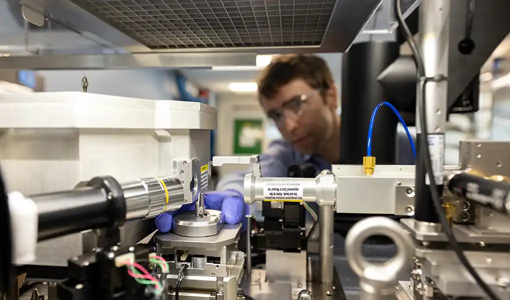 A researcher examines the X-ray nano-computed tomography (nano-CT) system.