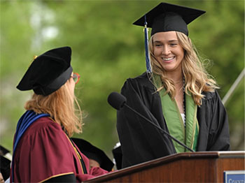 20240731-newsletter-sarah-hall Sarah Hall in a cap and gown at a commencement ceremony