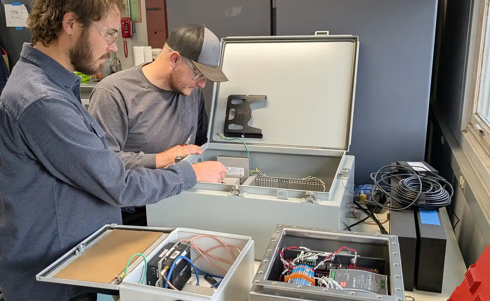 Researchers in a lab working on a marine energy device.